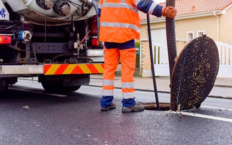 workers unblocking sewers